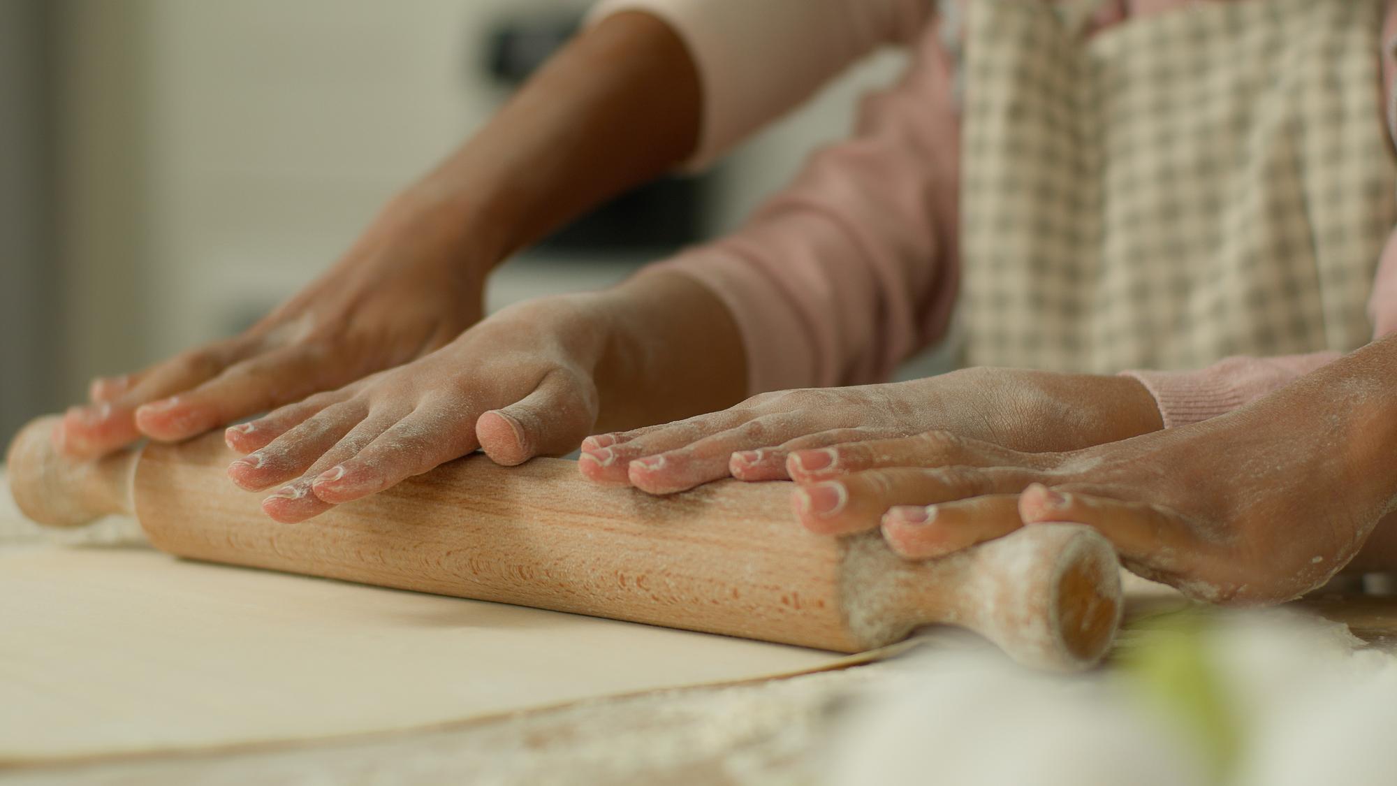 hands shaping dough in natural light